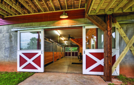 Entrance to Mountain Ranch Stables. Two red and white doors open